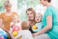 Young women in mother and child group playing with their baby kids