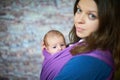 Young woman with newborn infant baby in a sling Royalty Free Stock Photo