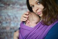 Young woman with newborn infant baby in a sling Royalty Free Stock Photo