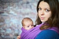 Young woman with newborn infant baby in a sling Royalty Free Stock Photo