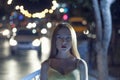 Young women in the night street posing on defocused carlights Royalty Free Stock Photo