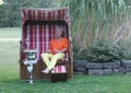 Attractive woman is celebrating her birthday in a roofed wicker beach chair