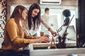 Young women in office working together on desktop Royalty Free Stock Photo