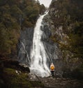 Young Women with orange backpack exploring Aber waterfalls