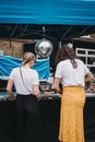 Young women ordering food from a market stall on Erza Street, London, UK. Royalty Free Stock Photo