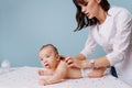 Woman pediatrician doing massage to baby boy