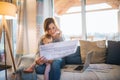 A young woman with a toddler daughter sitting indoors, working in home office. Royalty Free Stock Photo