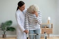 Young woman physiotherapist caregiver consoling sad injured old grandma patient Royalty Free Stock Photo