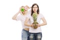 Young women with pineapple and cakes in their hands, a difficult choice. Isolated on white background Royalty Free Stock Photo