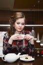Young women in a plaid shirt drinking tea Royalty Free Stock Photo