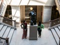 Young women play around Maillol sculpture in Chicago Art Institute