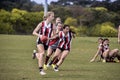 Young women play Australian Rules Football