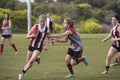 Young women play Australian Rules Football