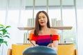 young women play tongue drum musical instrument in living room at home