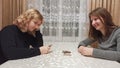 Women play uno cards at table