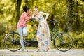 Young women posing by bicycle Royalty Free Stock Photo