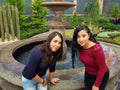 young women posing in a park fountain Royalty Free Stock Photo