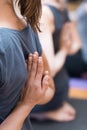 Women practicing yoga: reverse prayer pose