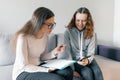 Young woman professional psychotherapist talking with teen girl in office. Mental health of child in adolescence