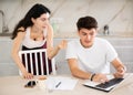 Young woman quarrels with young guy working at laptop Royalty Free Stock Photo