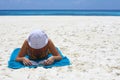 Young women is reading the book on the beach Royalty Free Stock Photo