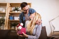 Woman receiving a surprise gift box from her boyfriend at home Royalty Free Stock Photo