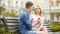 Young woman rejecting boyfriends proposal, disappointed with engagement ring