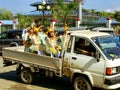 Young women riding in a back of a truck during wedding at Mahamuni Pagoda complex, Mandalay, Myanmar