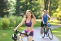 Young woman riding bicycle in park Royalty Free Stock Photo