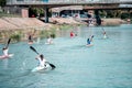 Young women rowing on kayak - Sport competitions on the water, rear side view