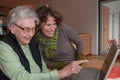 Young woman and senior woman with notebook Royalty Free Stock Photo