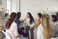 Young women sharing their life stories in therapy session or support group meeting Royalty Free Stock Photo