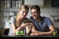 Young woman showing man smartphone screen, video, photos Royalty Free Stock Photo