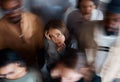 Alone in a room full of people. a young woman sitting on the floor with people around her. Royalty Free Stock Photo