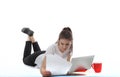 Young women is sitting on white background with laptop, cup, books and papers. Student girl studying, freelances is working.