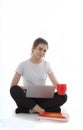 Young women is sitting on white background with laptop, cup, books and papers. Student girl studying, freelances is working.