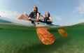 Young women smiling while kayaking in ocean