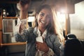 Smiling young woman standing on a bus listening to music Royalty Free Stock Photo