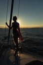 Young women standing on the edge of the sailboat