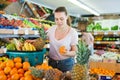 Young woman standing with full grocery cart during shopping Royalty Free Stock Photo