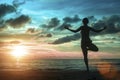 Young women standing at yoga pose on the beach during an amazing surreal sunset.