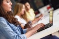 Young woman studying with laptop computer on white desk. Royalty Free Stock Photo