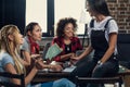 Young women studying together with books and digital devices indoors Royalty Free Stock Photo