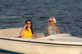 Young women in sunglasses sitting in motorboat Royalty Free Stock Photo