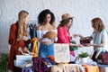 Young women at swap party. Casual clothes, shoes, hats, bags, jewellery