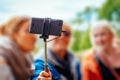 Young women taking a photo with a selfiestick