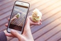 Young women is taking a picture of italian artisanal ice cream with her smartphone Royalty Free Stock Photo