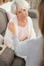 young woman talk with worried elderly mom