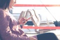 Young women texting on mobile phone waiting for flying at airport window