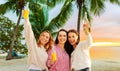 Young women toasting non alcoholic drinks on beach Royalty Free Stock Photo